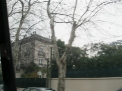 Blurred by the motion of the van, a fancy house in an elite neighborhood in Montevideo