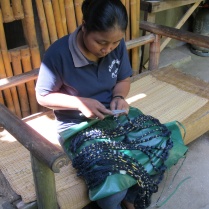 A dyer prepping a skein for the ikat technique (tie-dye)